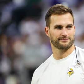 Minnesota Vikings quarterback Kirk Cousins (8) looks on from the bench