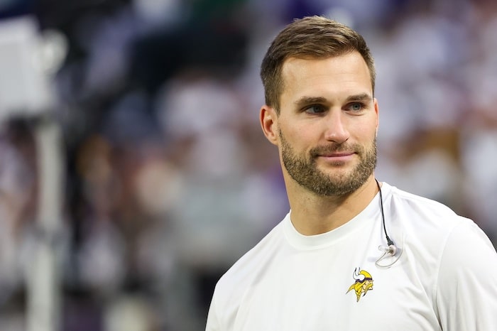 Minnesota Vikings quarterback Kirk Cousins (8) looks on from the bench