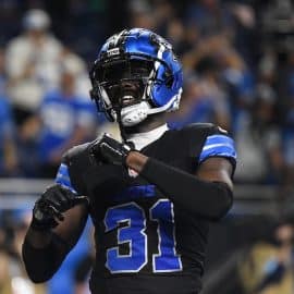 Kerby Joseph puts his hands up and celebrates.
