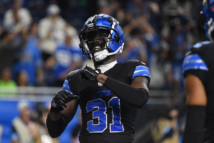 Kerby Joseph puts his hands up and celebrates.