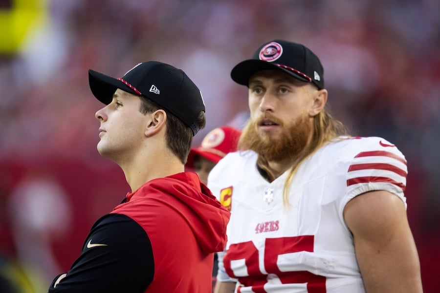 San Francisco 49ers quarterback Brock Purdy (left) with tight end George Kittle stand on the sideline.