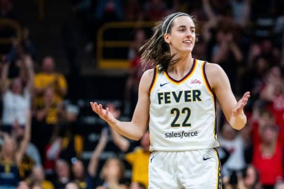 Indiana Fever guard Caitlin Clark holds her hands out.