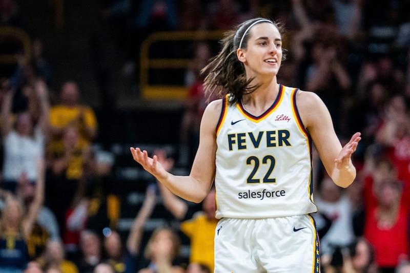 Indiana Fever guard Caitlin Clark holds her hands out.