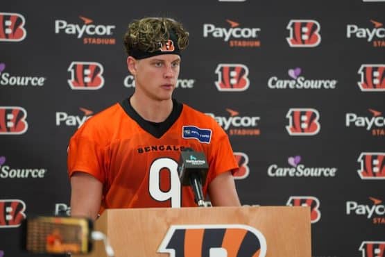 Joe Burrow stands in front of the mic.