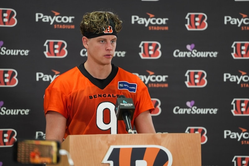 Joe Burrow stands in front of the mic.