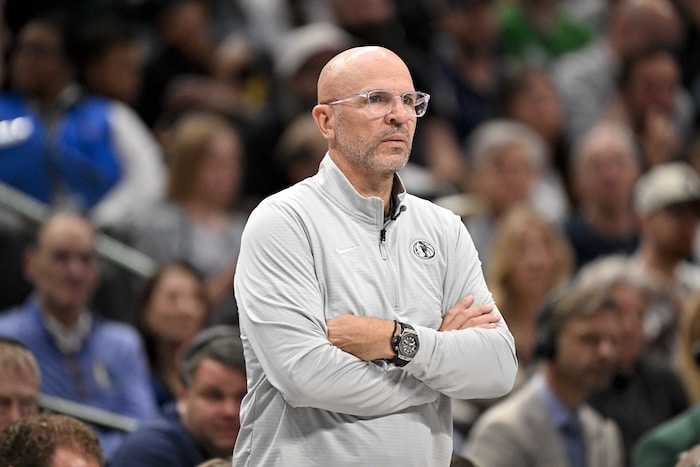 Dallas Mavericks head coach Jason Kidd covers his arms.