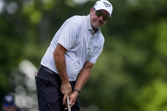 Phil Mickelson stares at a putt.