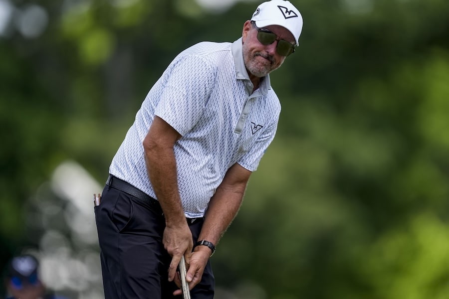 Phil Mickelson stares at a putt.