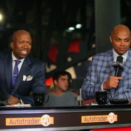 Kenny Smith and Charles Barkley sit at the sports desk.