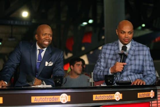 Kenny Smith and Charles Barkley sit at the sports desk.